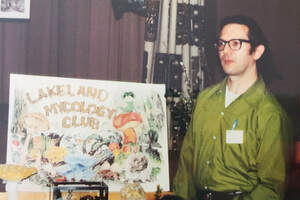 Picture - Hiram Korm with Lakeland Mycology Club poster